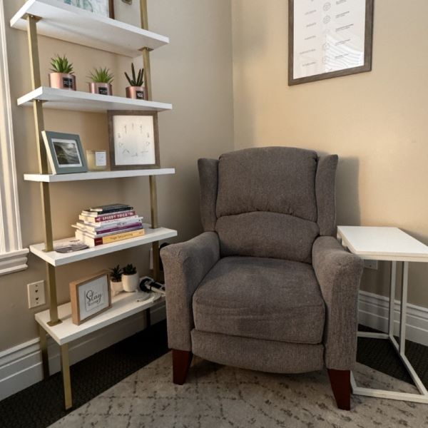 Gray-Lounge-Chair-White-Bookcase-in-Draper-Office-Rooted-Counseling-Wellness