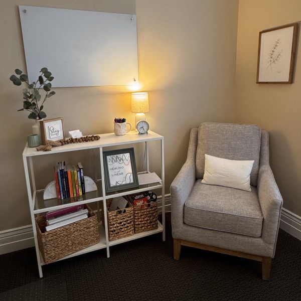 Gray-Lounge-Chair-White-Shelves-in-Draper-Office-Rooted-Counseling-Wellness